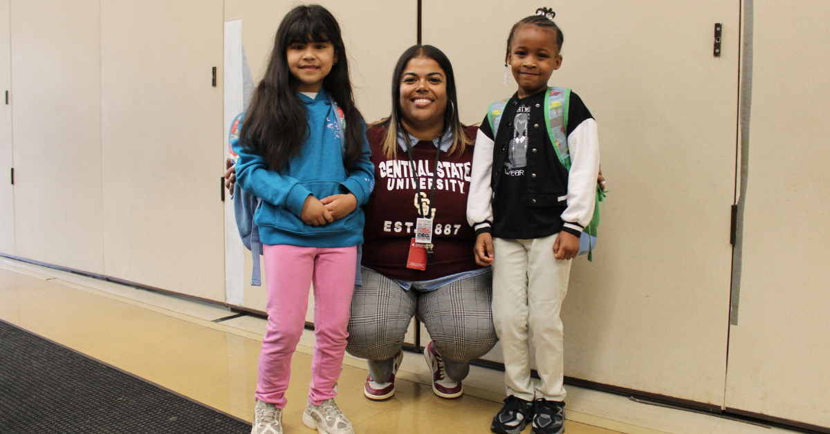teacher standing with students
